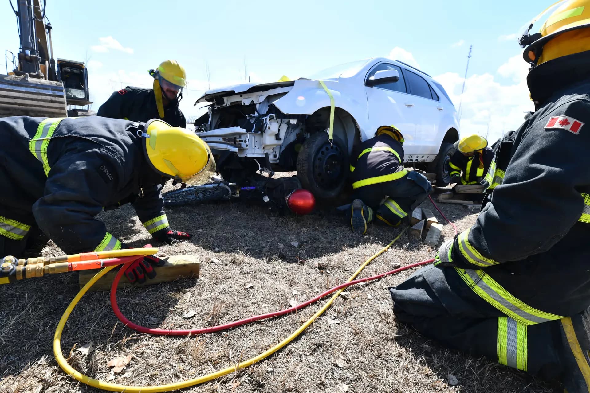 Firefighters conducting hands-on vehicle extrication training